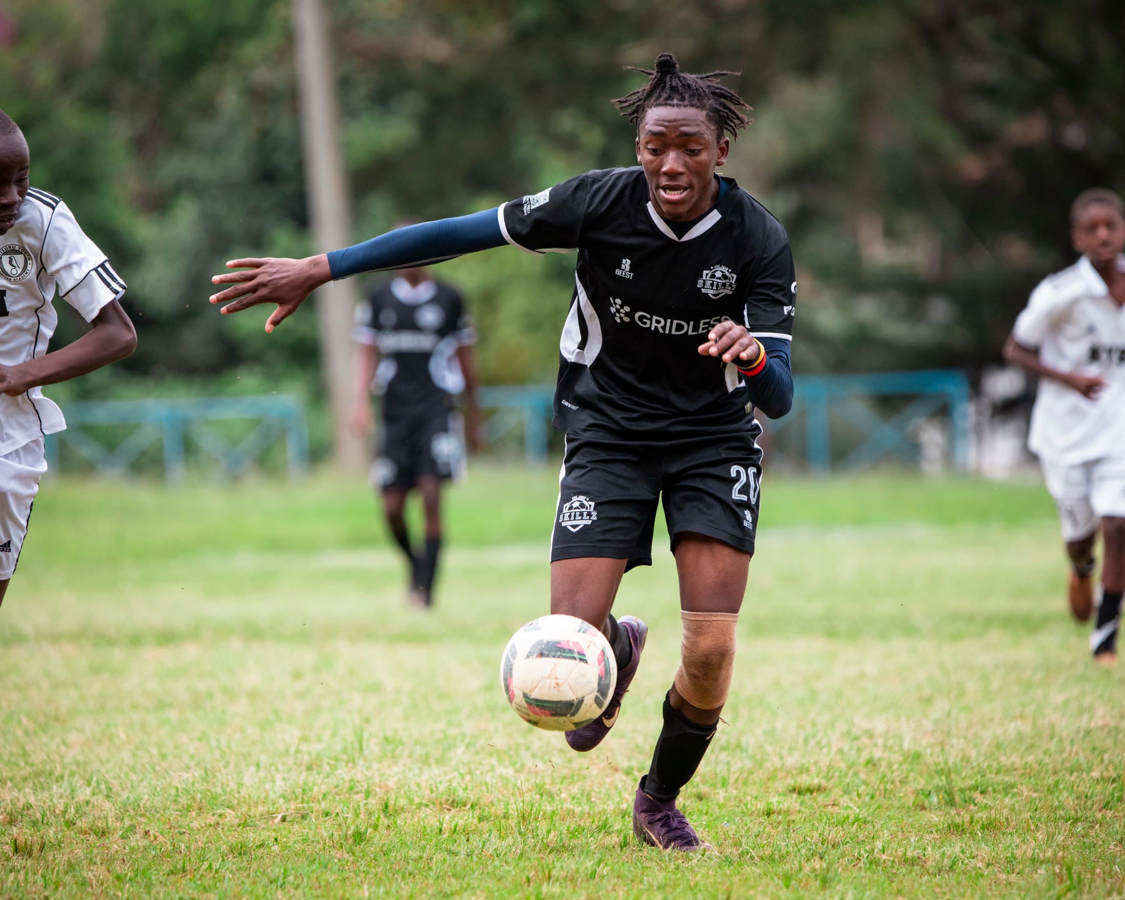 Skillz Academy player running with the ball during a match
