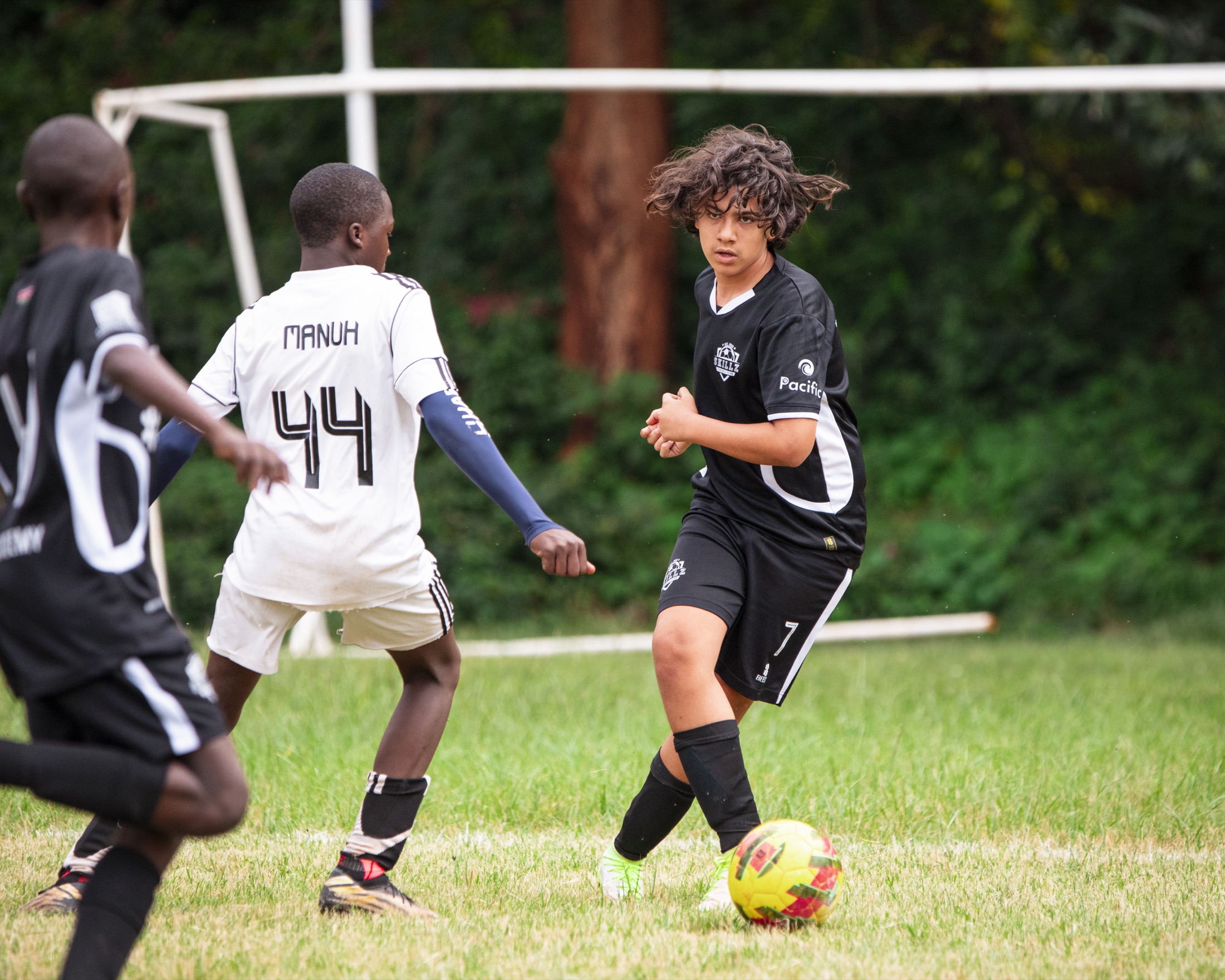 Skillz FC Academy player receiving the ball under pressure